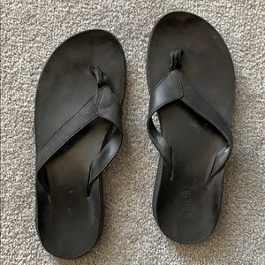 Black leather Chaco flip flops